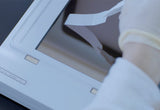 Gloved hand placing a Western blot membrane directly onto the photosensitive chip of the e-BLOT Touch Imager